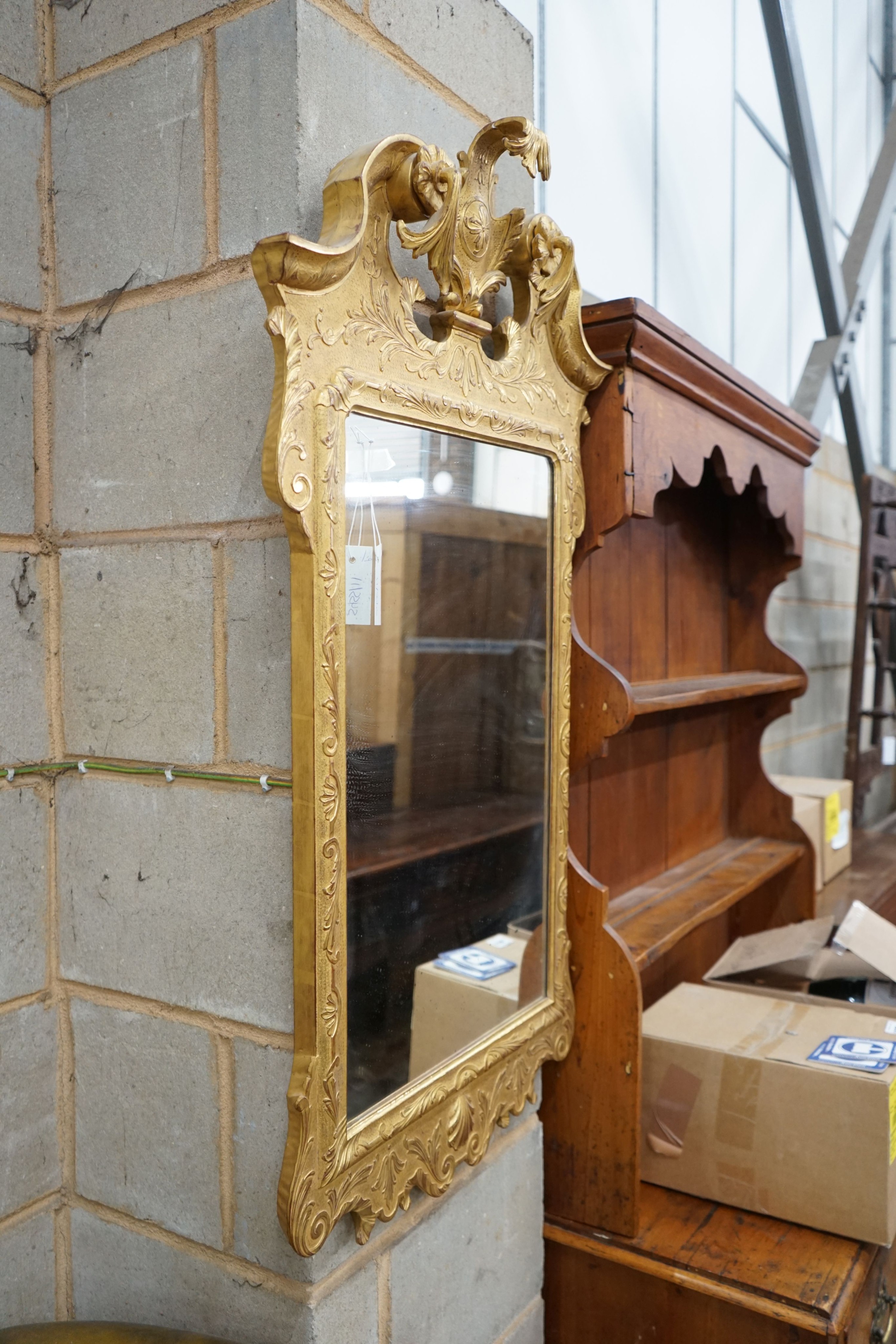 A pair of George II style carved giltwood wall mirrors, with scroll pediments, width 58cm, height 106cm